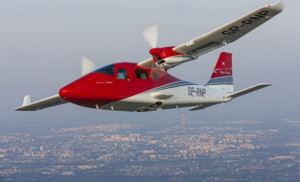 Tecnam P2006 flying over city