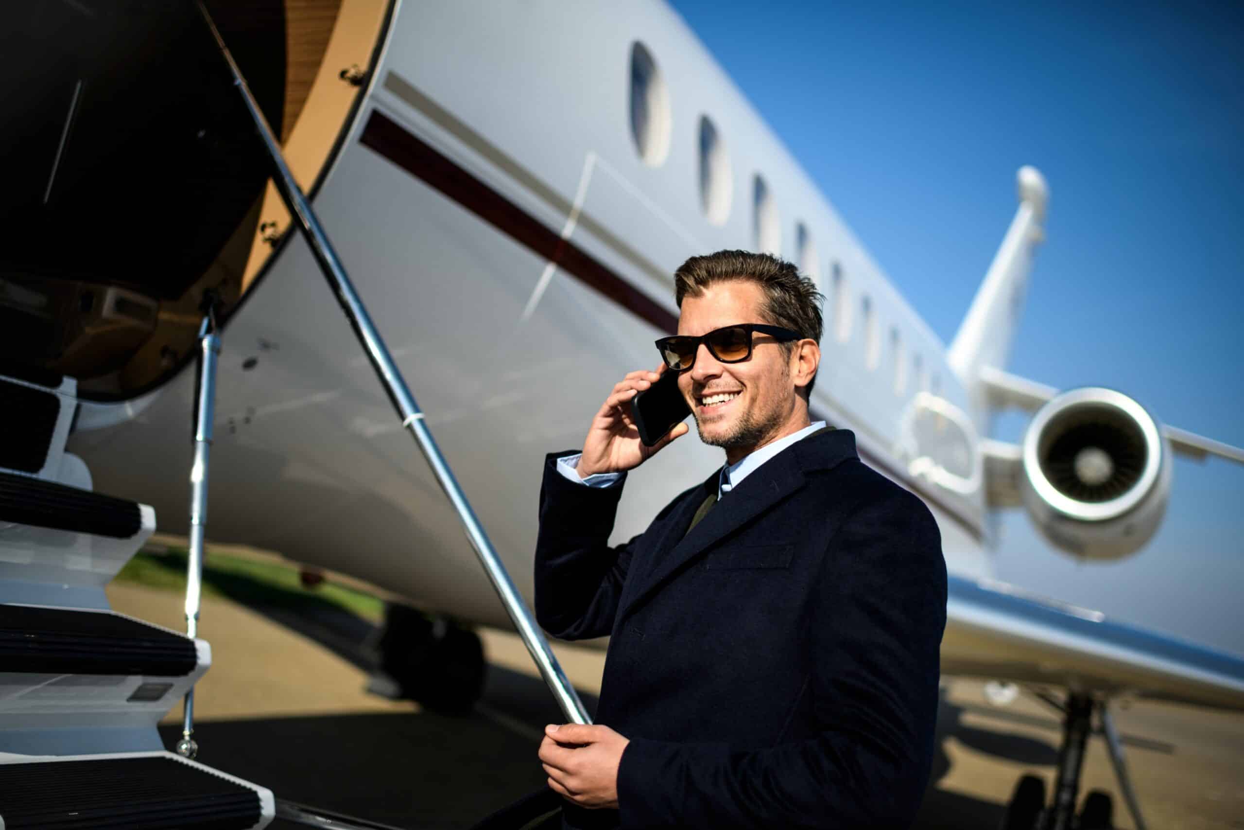 iStock-893410954 - Smartly Dressed Man with Phone and Jet LR